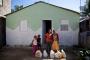 Luisa and family outside their new home with their groceries